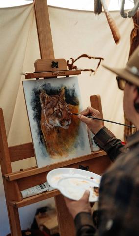 Manny painting a picture of a wild animal