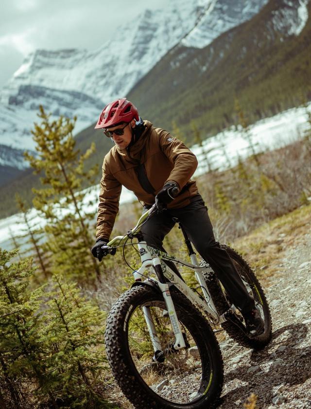 A man riding a bike wearing Aktivator jacket