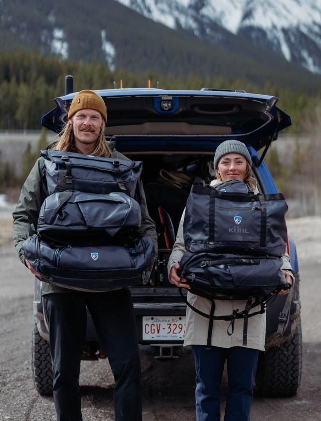 Man and woman holding Eskape bags