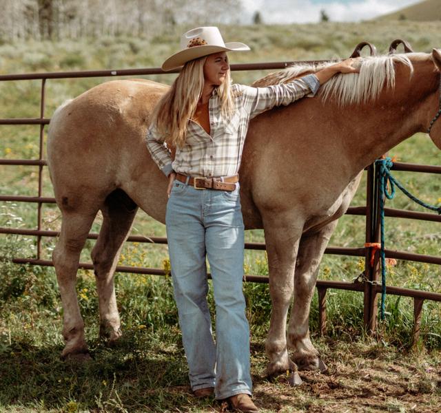 A women standing next to a horse wearing Kontour Rigid Wide-Leg Denim.